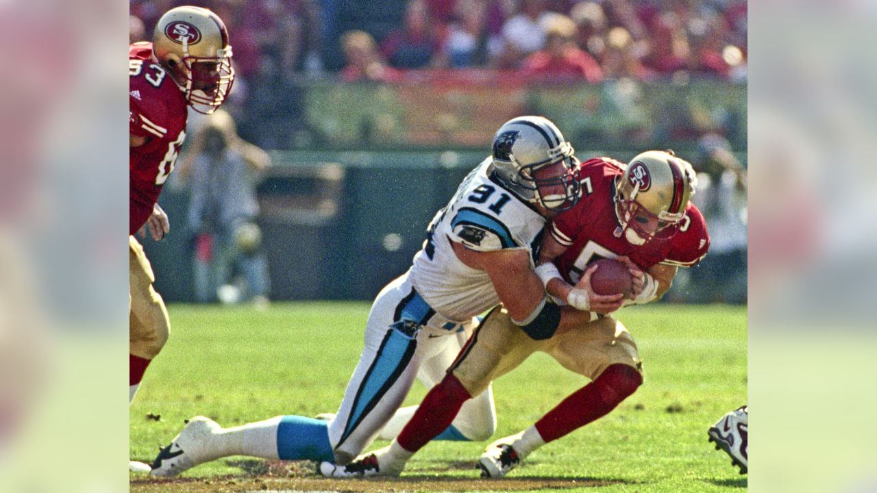 Carolina Panthers' Fred Lane (32) is hit by San Francisco 49ers' Ken Norton,  Jr, after an eight-yard gain in the first quarter at Ericsson Stadium in  Charlotte, N.C., Saturday, Dec. 18, 1999.(AP