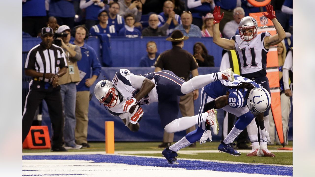 New England Patriots wide receiver Julian Edelman (11) is congratulated by  teammate Sebastian Vollmer after catching a touchdown against the  Indianapolis Colts in the first half of an NFL football game in