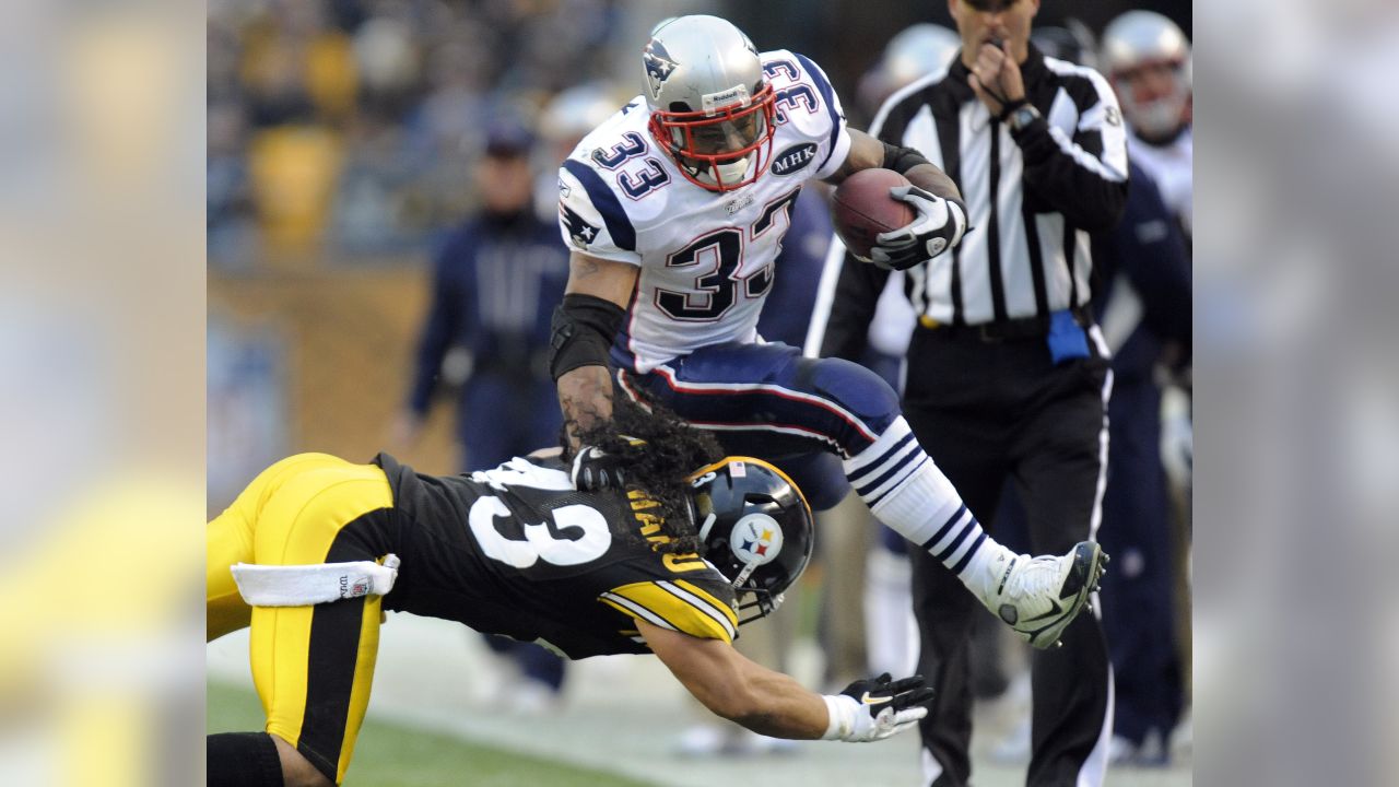 New England Patriot running back Kevin Faulk takes the ball from