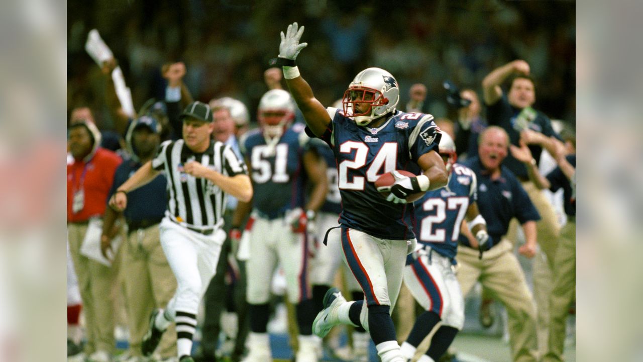 New England Patriots Richard Seymour, left, shows his Super Bowl ring and  gestures a three as teammate Ty Law gestures a three as they ride in a  duckboat during the rolling rally