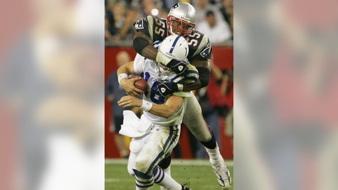 Willie McGinst, of the New England Patriots, holds up the AFC Championship  Trophy, as he walks around the field, at Gillette Stadium, following the  Patriots victory of the Indianapolis Colts, in the