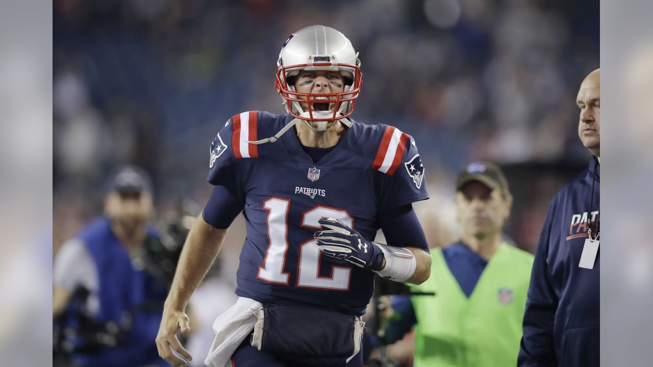 New England Patriots quarterback Tom Brady (12) gives high fives to members  of the United States Armed Forces before the game against the Atlanta  Falcons at Gillette Stadium in Foxborough, Massachusetts on