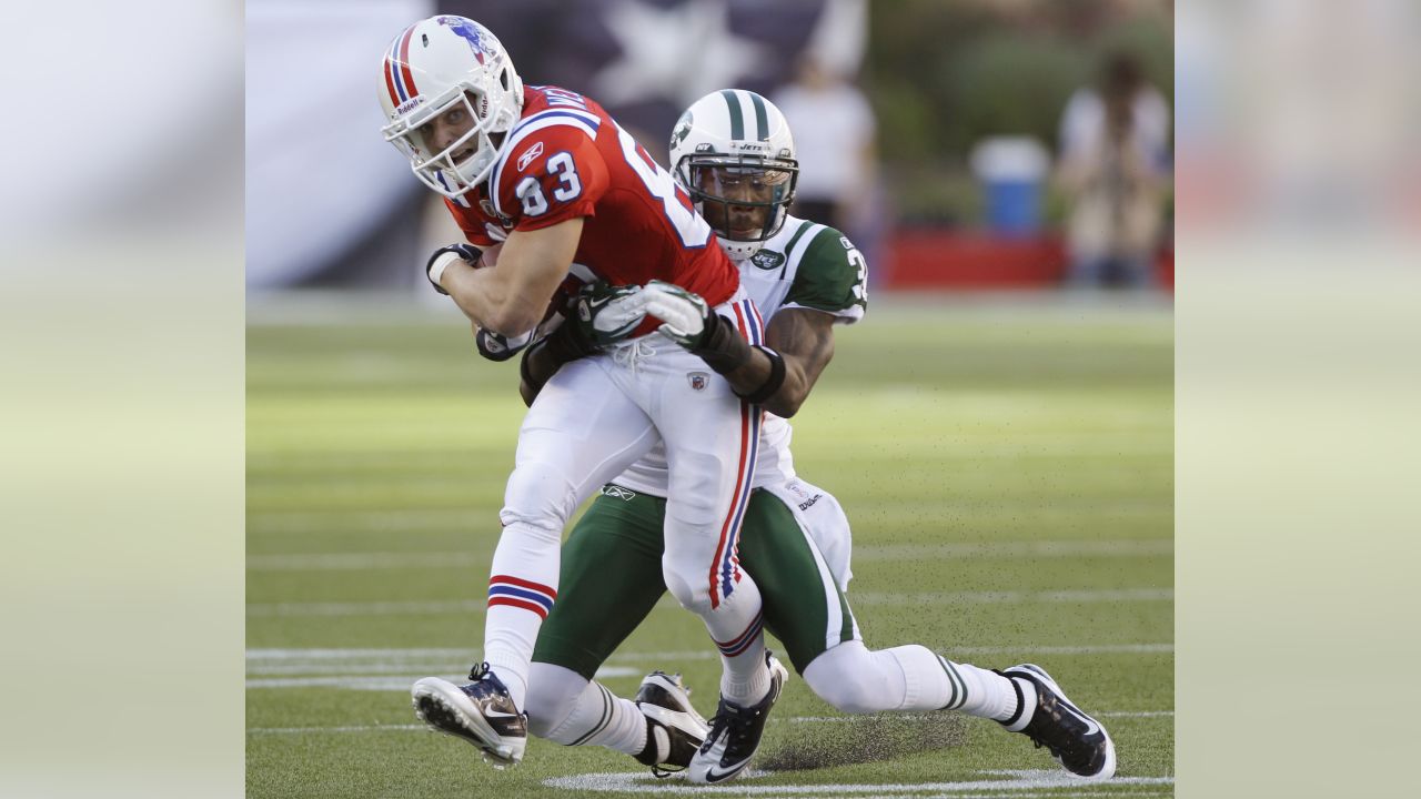 New England Patriots' Aaron Hernandez (81) is tackled by New York Jets'  Kyle Wilson (20) and Jim Leonhard (36) during the third quarter of an NFL  football game Sunday, Nov. 13, 2011