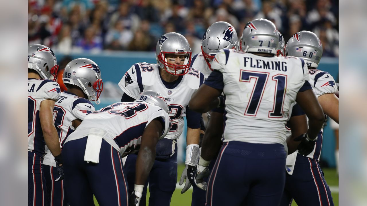 New England Patriots quarterback Tom Brady (12) cheers the offensive line  on the field, during the second half of an NFL football game against the  Miami Dolphins, Monday, Dec. 11, 2017, in