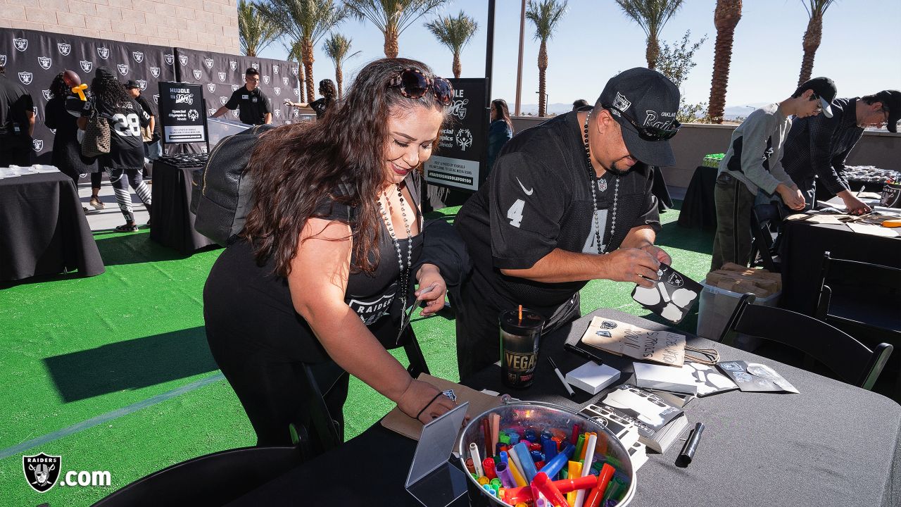 Oakland Raider fans pose during tailgating festivities before game