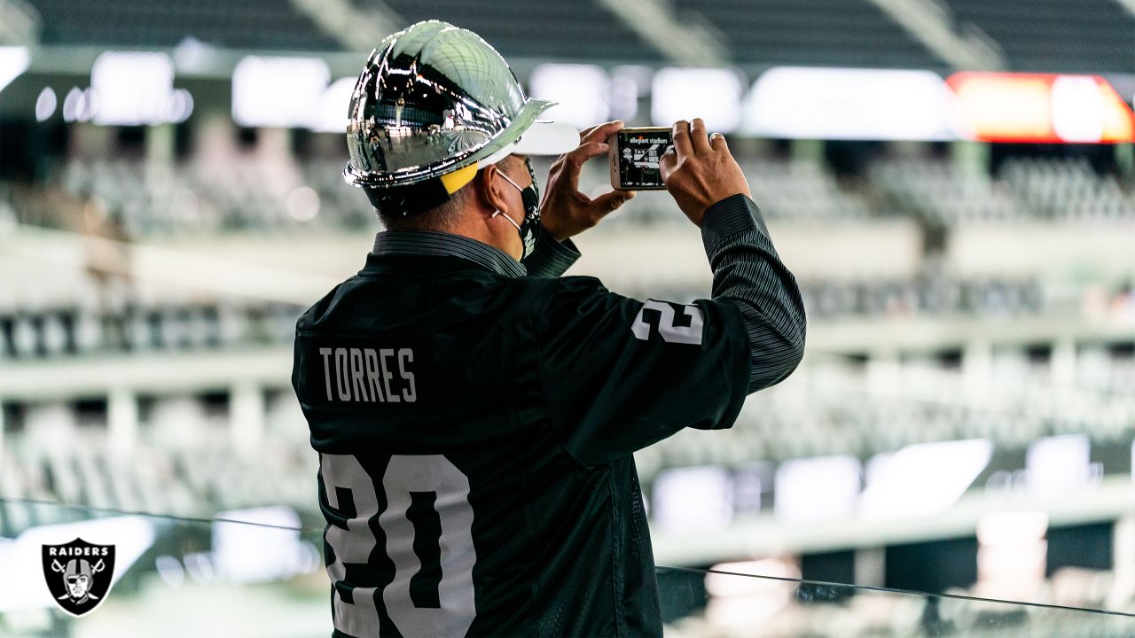 Allegiant Stadium construction workers light Al Davis Memorial Torch