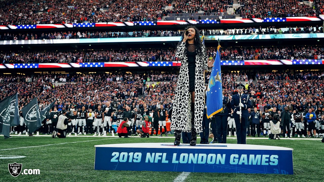 Fans wave team flags at an NFL game between the Oakland Raiders and the  Chicago Bears at Totten …