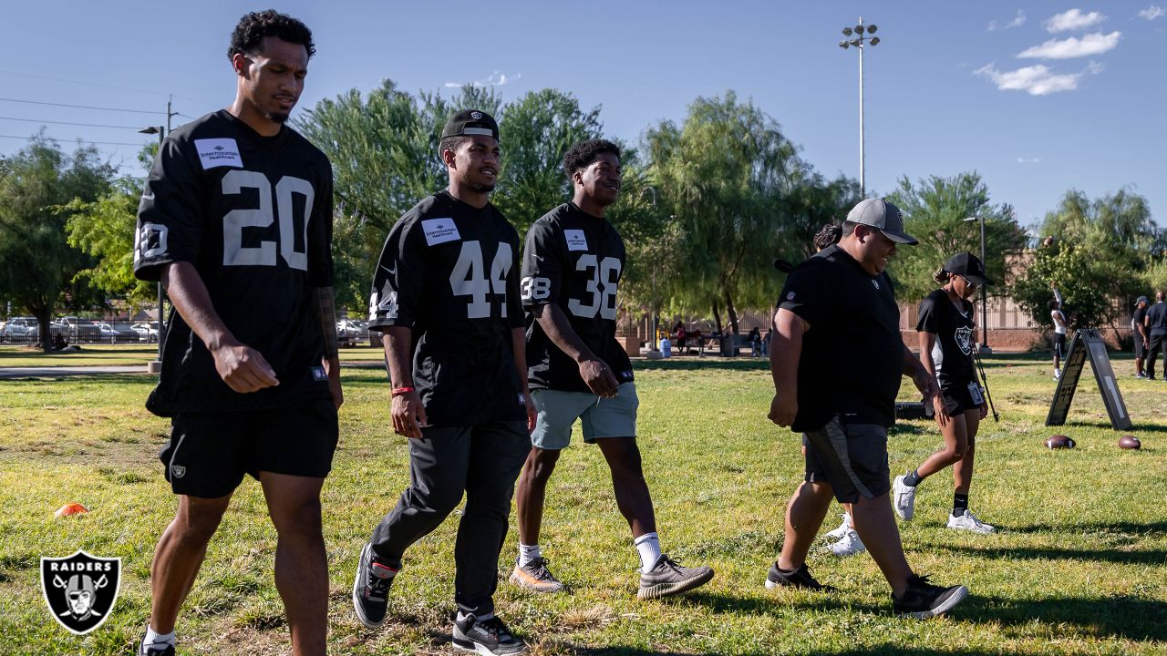 Las Vegas Raiders players lead elementary school students at football camp  in advance of Silver & Black Flag League kickoff