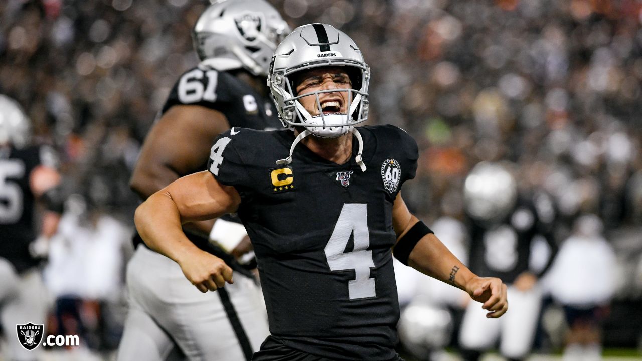 Oakland Raiders quarterback Derek Carr (4) talks with Chicago