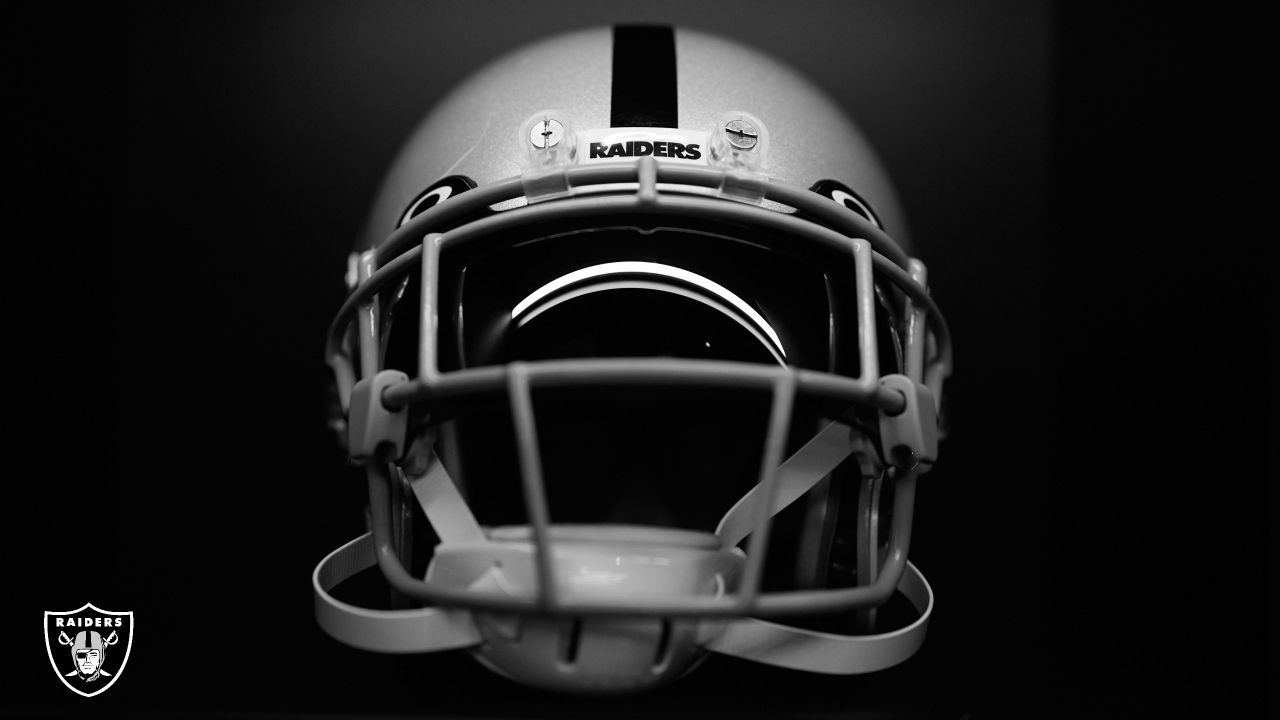 A closeup of a Las Vegas Raiders NFL team helmet on white