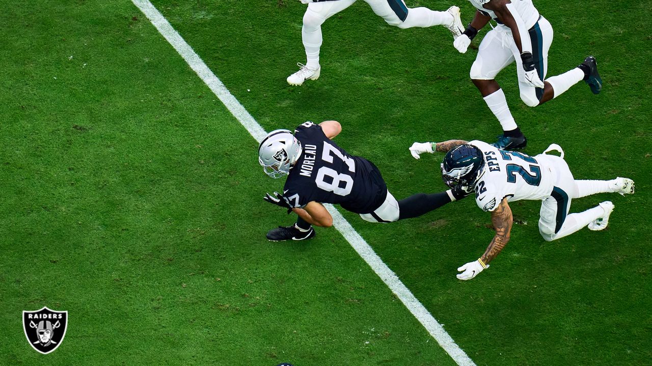 Raiders tight end Foster Moreau (87) gestures to a reporter during