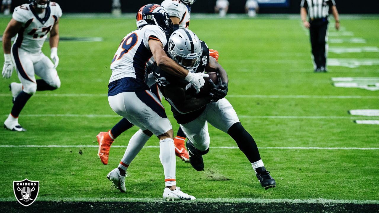 Las Vegas Raiders running back Josh Jacobs (28, left) jokes around with  head coach Jon Gruden d …