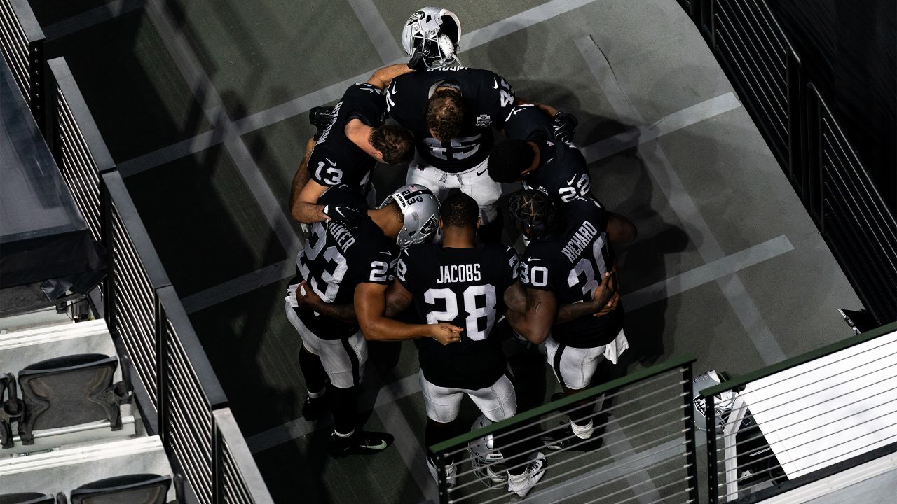 Las Vegas Raiders players huddle before the start of a NFL