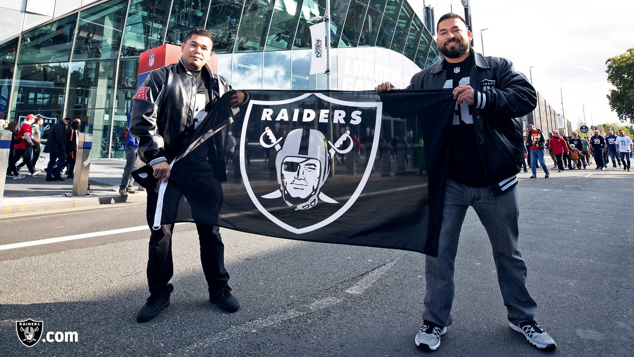 Fans wave team flags at an NFL game between the Oakland Raiders and the  Chicago Bears at Totten …