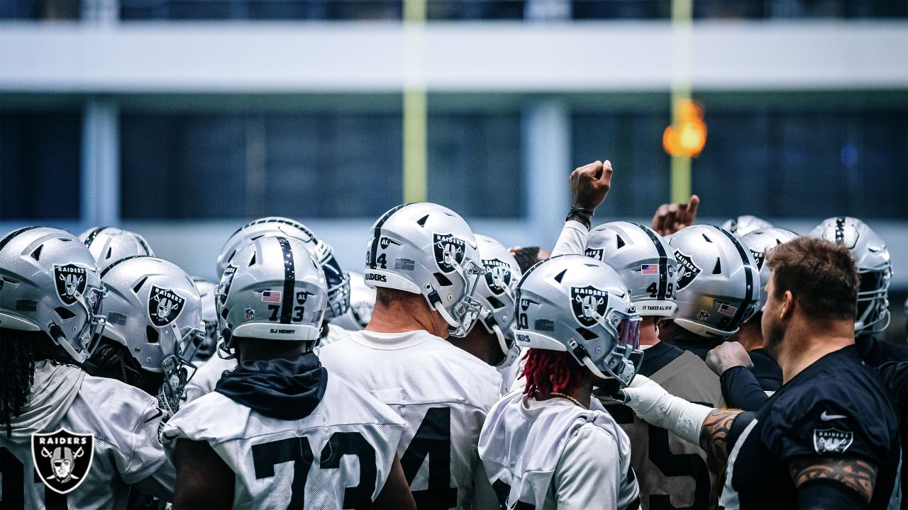 Las Vegas Raiders players huddle before the start of a NFL