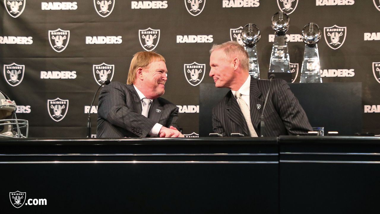 Mike Mayock, right, introduces members of his family to Oakland Raiders  owner Mark Davis, second from right, and head coach Jon Gruden, third from  left, at a news conference announcing Mayock as