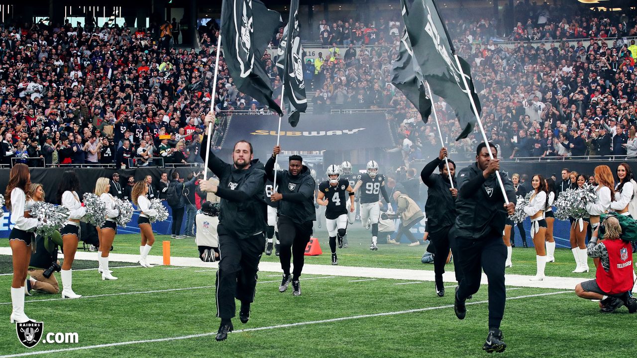 Fans wave team flags at an NFL game between the Oakland Raiders and the  Chicago Bears at Totten …