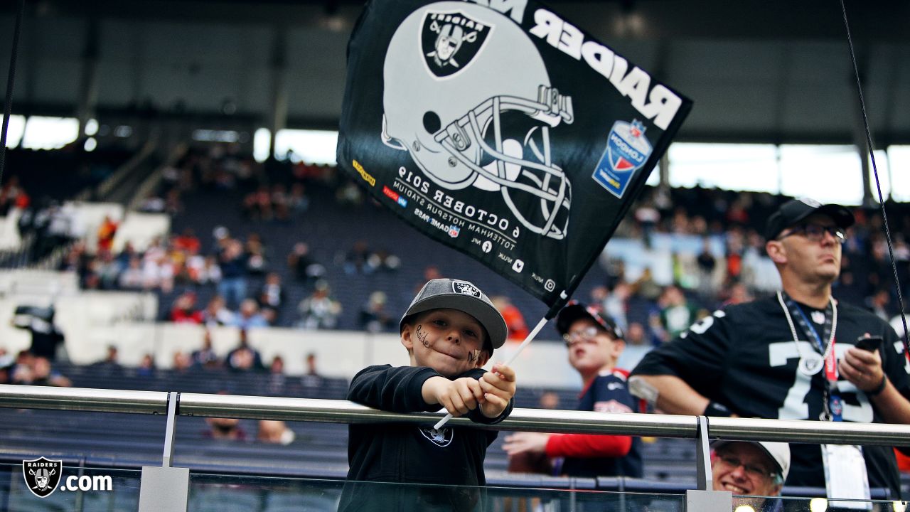 Fans wave team flags at an NFL game between the Oakland Raiders and the  Chicago Bears at Totten …