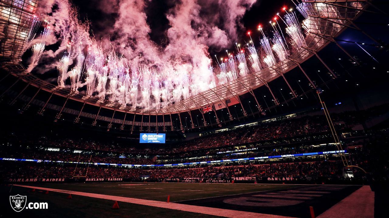 Fans wave team flags at an NFL game between the Oakland Raiders and the  Chicago Bears at Totten …