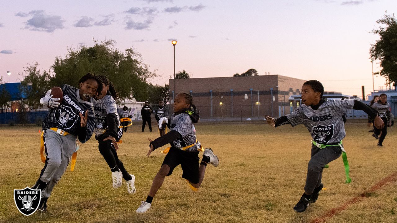 Las Vegas Raiders players lead elementary school students at football camp  in advance of Silver & Black Flag League kickoff