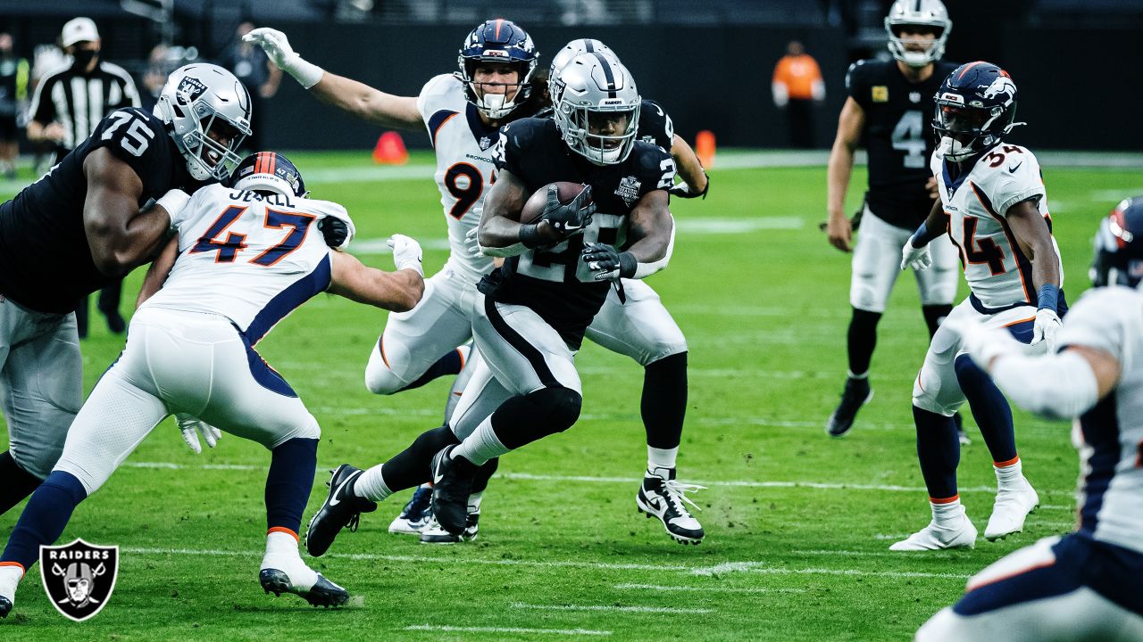 Las Vegas Raiders running back Josh Jacobs (28, left) jokes around with  head coach Jon Gruden d …