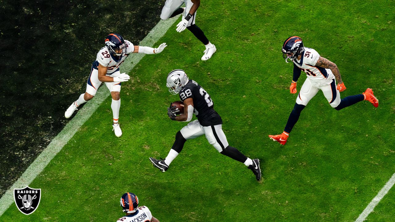 Oakland Raiders running back Josh Jacobs (28) breaks a tackle and