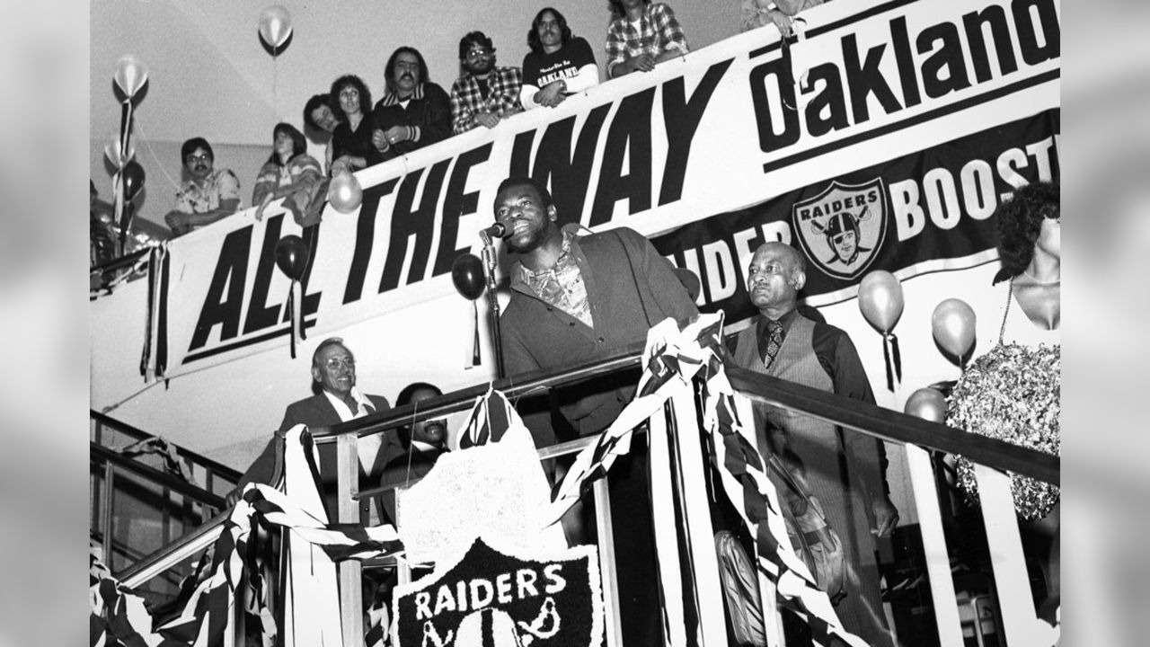 Oakland Raiders quarterback Jim Plunkett takes a snap during the playoff  game between the Cleveland Browns and the Oakland Raiders at Cleveland  Stadium on Jan. 4, 1981. Gene Upshaw is number 63