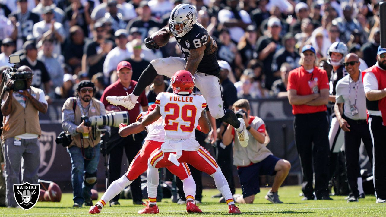 Raiders offensive tackle Trent Brown (77) fist bumps Raiders tight end  Darren Waller (83) in th …