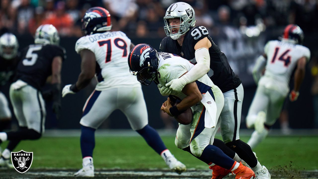 Oakland Raiders defensive end Maxx Crosby (98) gestures after being  penalized for roughing the …