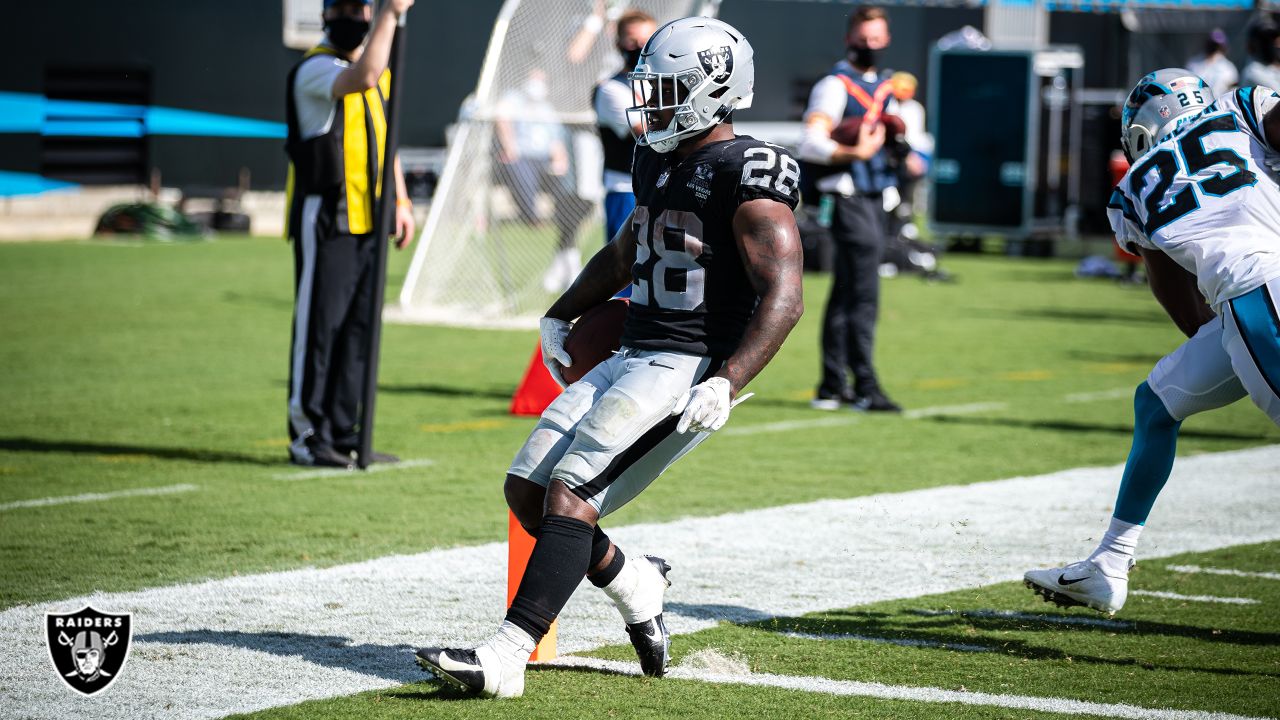 Las Vegas Raiders running back Josh Jacobs (28, left) jokes around with  head coach Jon Gruden d …