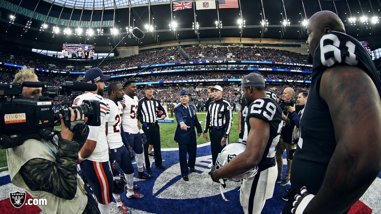 Fans wave team flags at an NFL game between the Oakland Raiders and the  Chicago Bears at Totten …