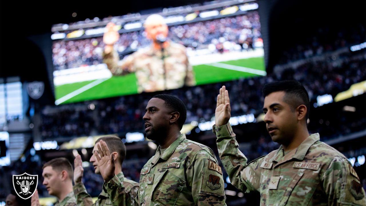 Service members from all five branches of the armed services carry a large  American flag out onto the field at the Salute to Service Chicago Bears  game Nov. 27 at Soldier Field