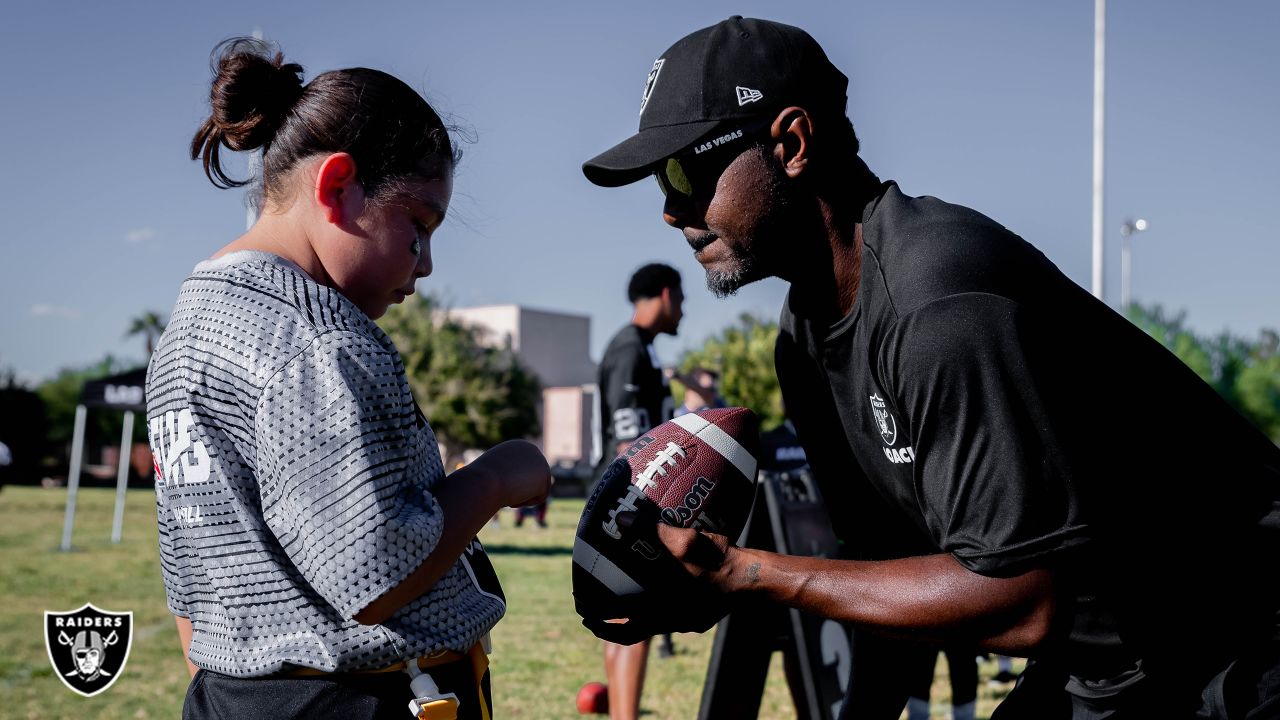 Las Vegas Raiders players lead elementary school students at football camp  in advance of Silver & Black Flag League kickoff