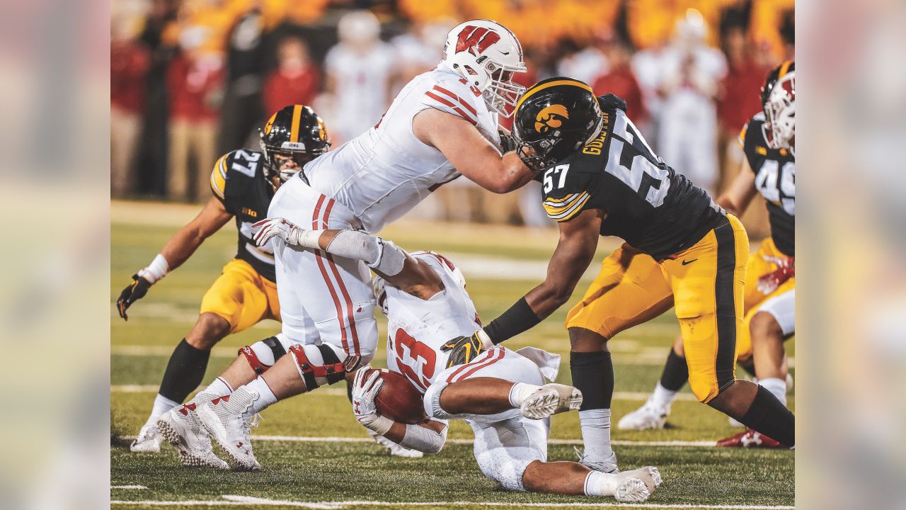 FILE - In this Sept. 22, 2018 file photo Wisconsin offensive lineman David  Edwards, center, blocks Iowa defensive end Chauncey Golston, left, from  quarterback Alex Hornibrook, right, during the first half of