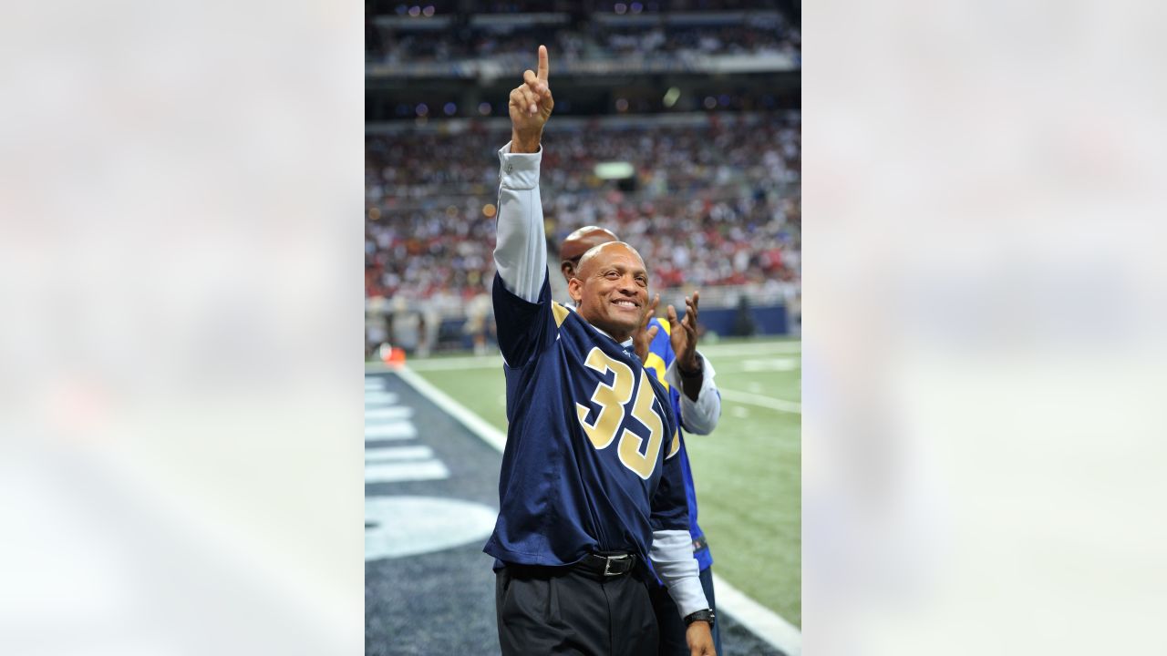 St. Louis Rams' Aeneas Williams, holds his son, Lazarus, as he celebrates  the Rams' 29-24 victory over the Philadelphia Eagles in the NFC Championship  game Sunday, Jan. 27, 2002 in St. Louis. (