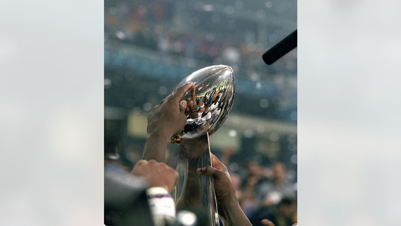 Former St. Louis Rams Isaac Bruce holds the Super Bowl trophy