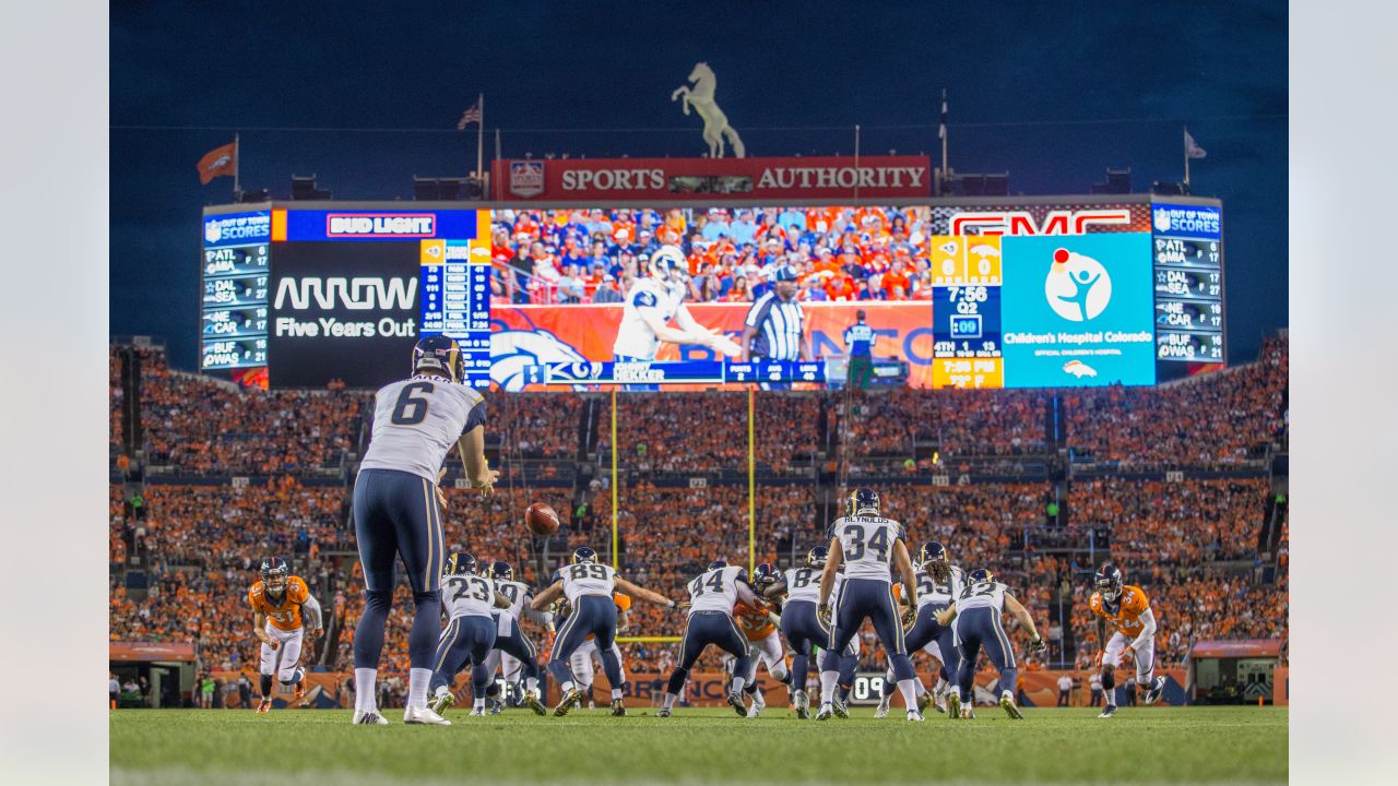 Denver, Colorado USA – 19 January 2014. Football fans tailgate in the  parking lot of Sports Authority Field at Mile High before the AFC playoff  game between the Denver Broncos and New