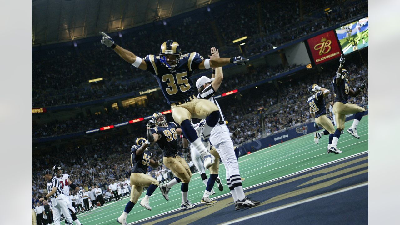 Workers removing Rams banners from the Edward Jones Dome