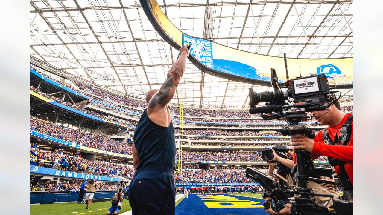 Dwayne Johnson, aka The Rock, looks onto the field before the Los Angeles  Rams play the Buffalo Bills during an NFL football game Thursday, Sept. 8,  2021, in Inglewood, Calif. (AP Photo/John