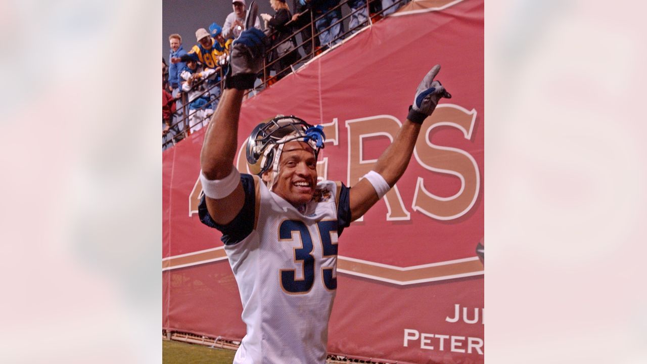 St. Louis Rams' Aeneas Williams, holds his son, Lazarus, as he celebrates  the Rams' 29-24 victory over the Philadelphia Eagles in the NFC Championship  game Sunday, Jan. 27, 2002 in St. Louis. (