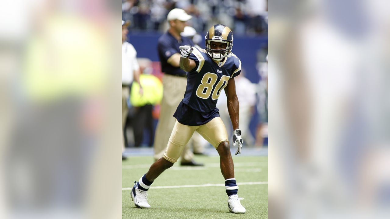 St. Louis Rams wide receiver Isaac Bruce holds one of his jerseys