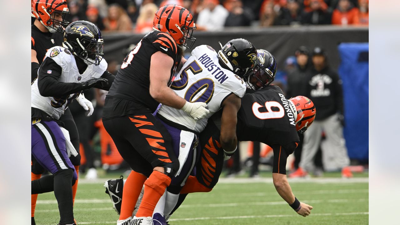 Baltimore Ravens vs. Cincinnati Bengals. NFL match poster. Two american  football players silhouette facing each other on the field. Clubs logo in  background. Rivalry concept photo. Stock Photo