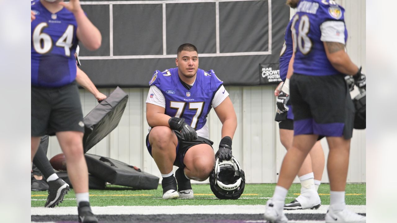 Baltimore Ravens center Tyler Linderbaum (64) signals during an