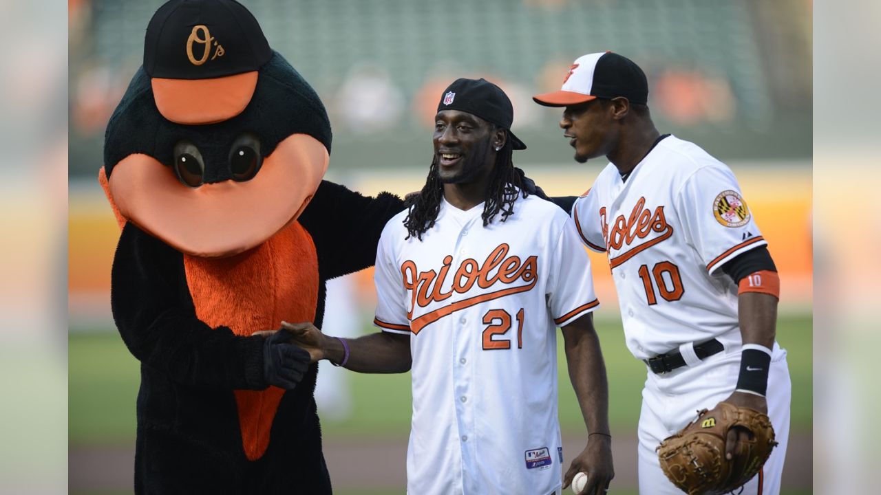 Former Baltimore Orioles players pose for a photo with Adam Jones