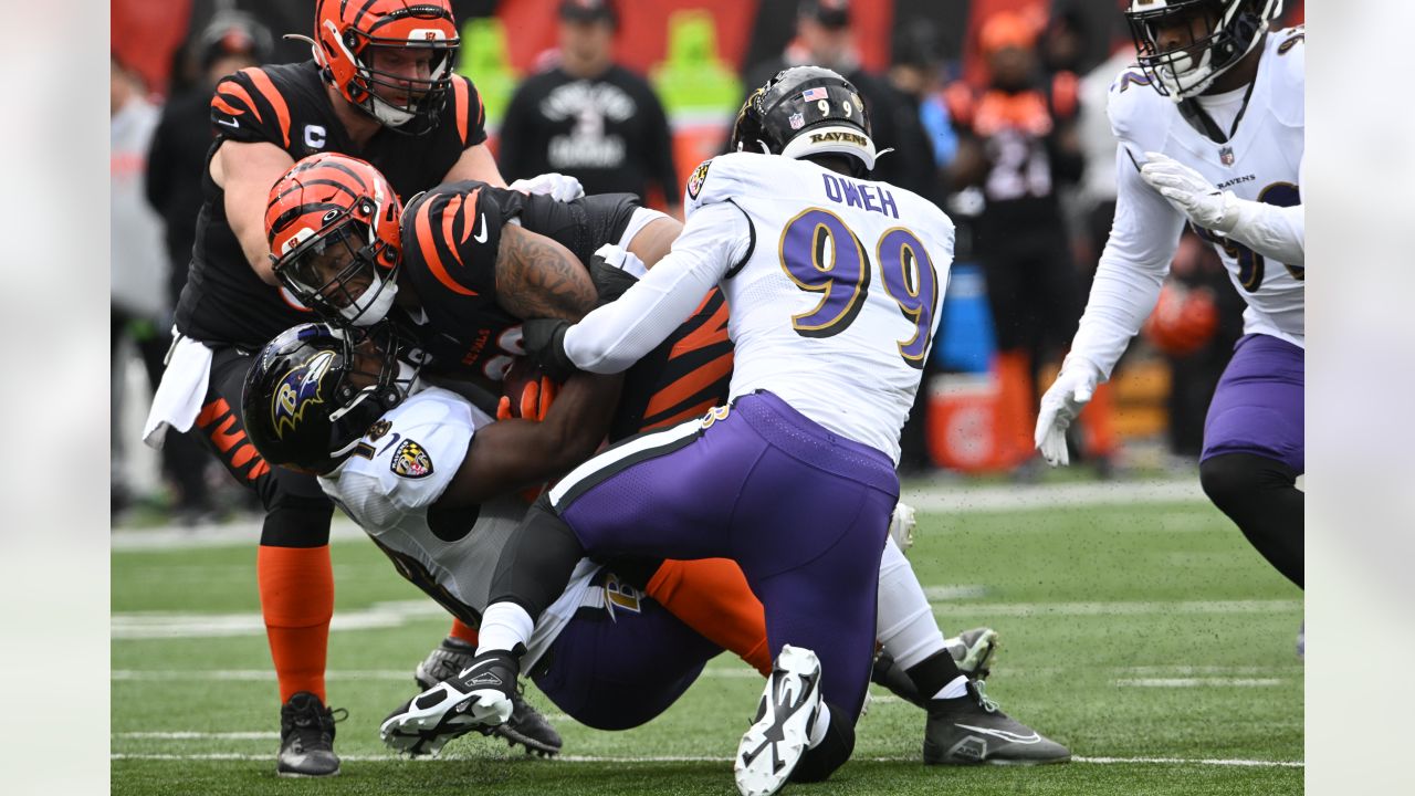 Baltimore Ravens vs. Cincinnati Bengals. NFL match poster. Two american  football players silhouette facing each other on the field. Clubs logo in  background. Rivalry concept photo. Stock Photo