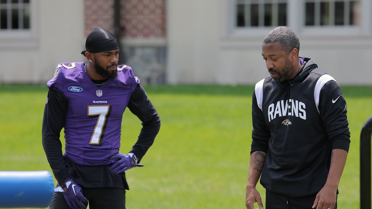 Ravens special teams consultant Sam Koch coaches up P Jordan Stout