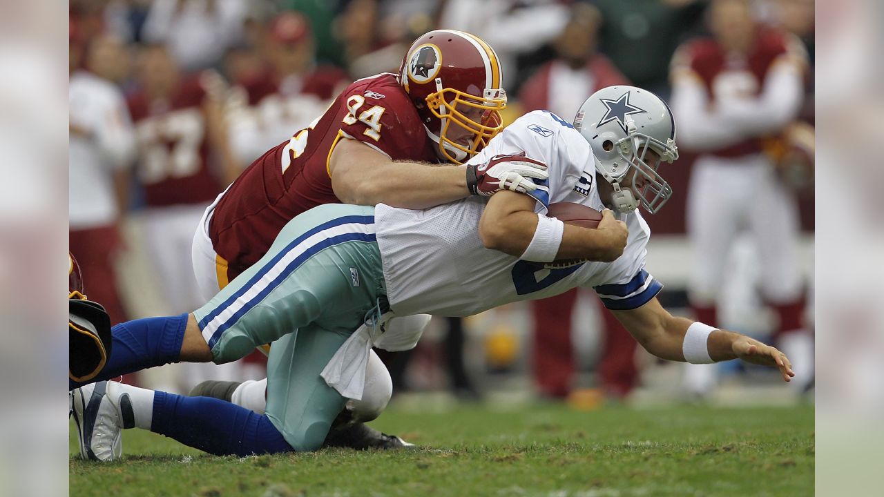 Washington Redskins defensive end Adam Carriker (94) talks with outside  linebacker Ryan Kerrigan (91) during the third quarter of an NFL football  game against the Miami Dolphins, Sunday, Nov. 13, 2011, in