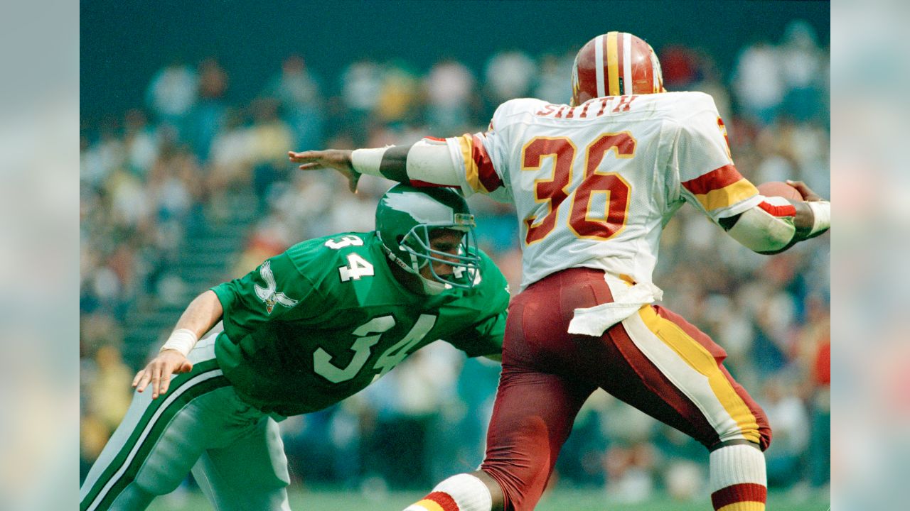 Bill Dudley (35) Washington halfback, eludes a tackle by Philadelphia Eagles  end Norm Willey for a short gain in the second period of the Redskins-Eagles  National Football League game Oct. 28, 1951