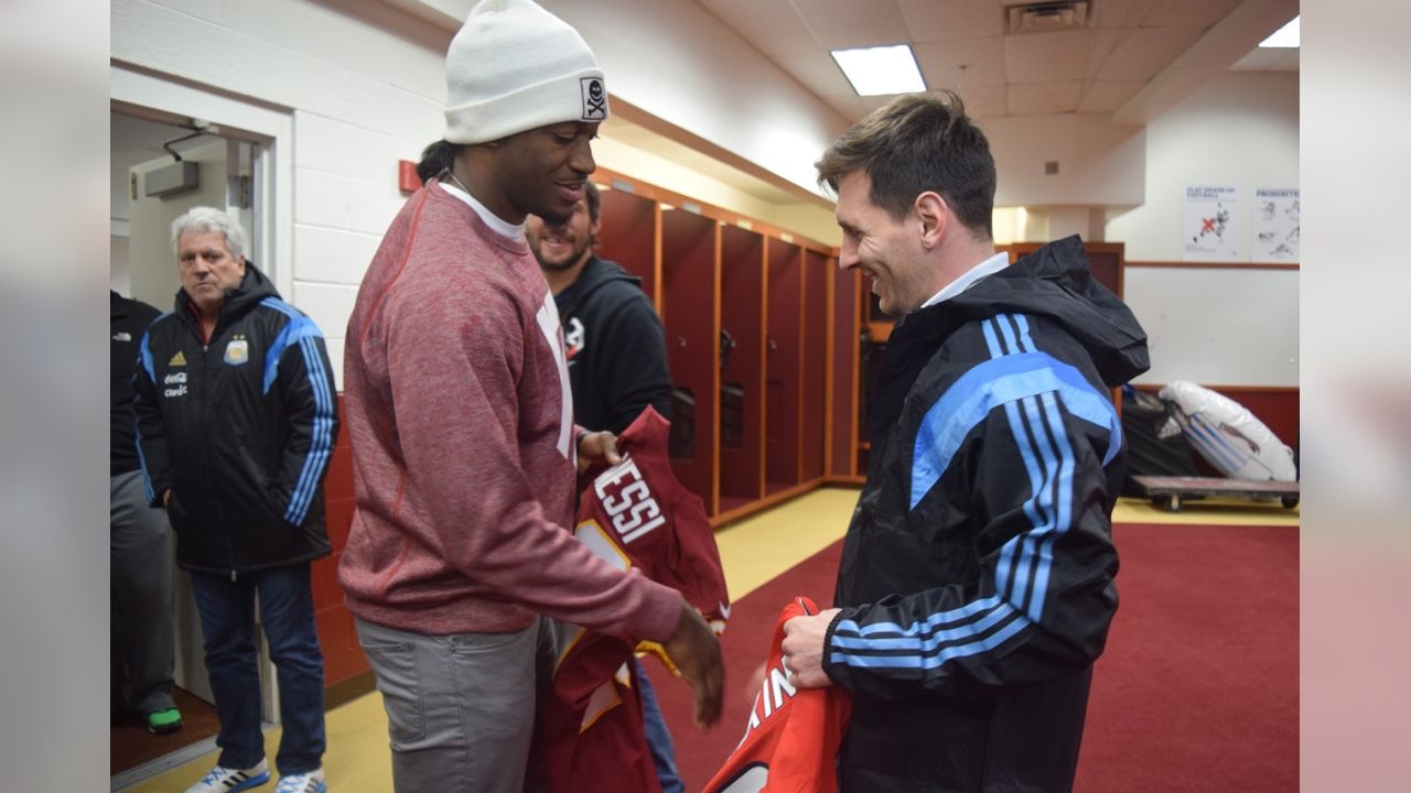 LOOK: Robert Griffin III presents Lionel Messi with Redskins