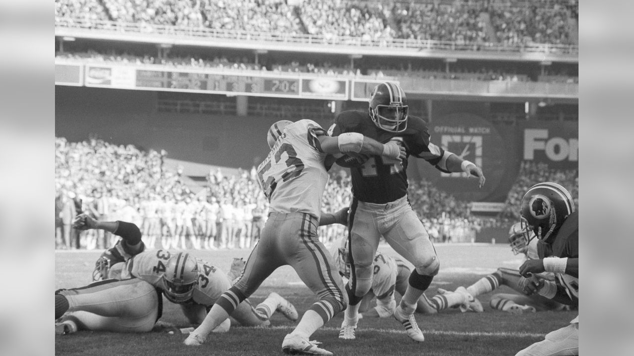 Washington, District of Columbia, USA. 31st Dec, 1972. Dallas Cowboys  quarterback Roger Staubach (12) looks for a received during the NFC  Championship game against the Washington Redskins at RFK Stadium in  Washington